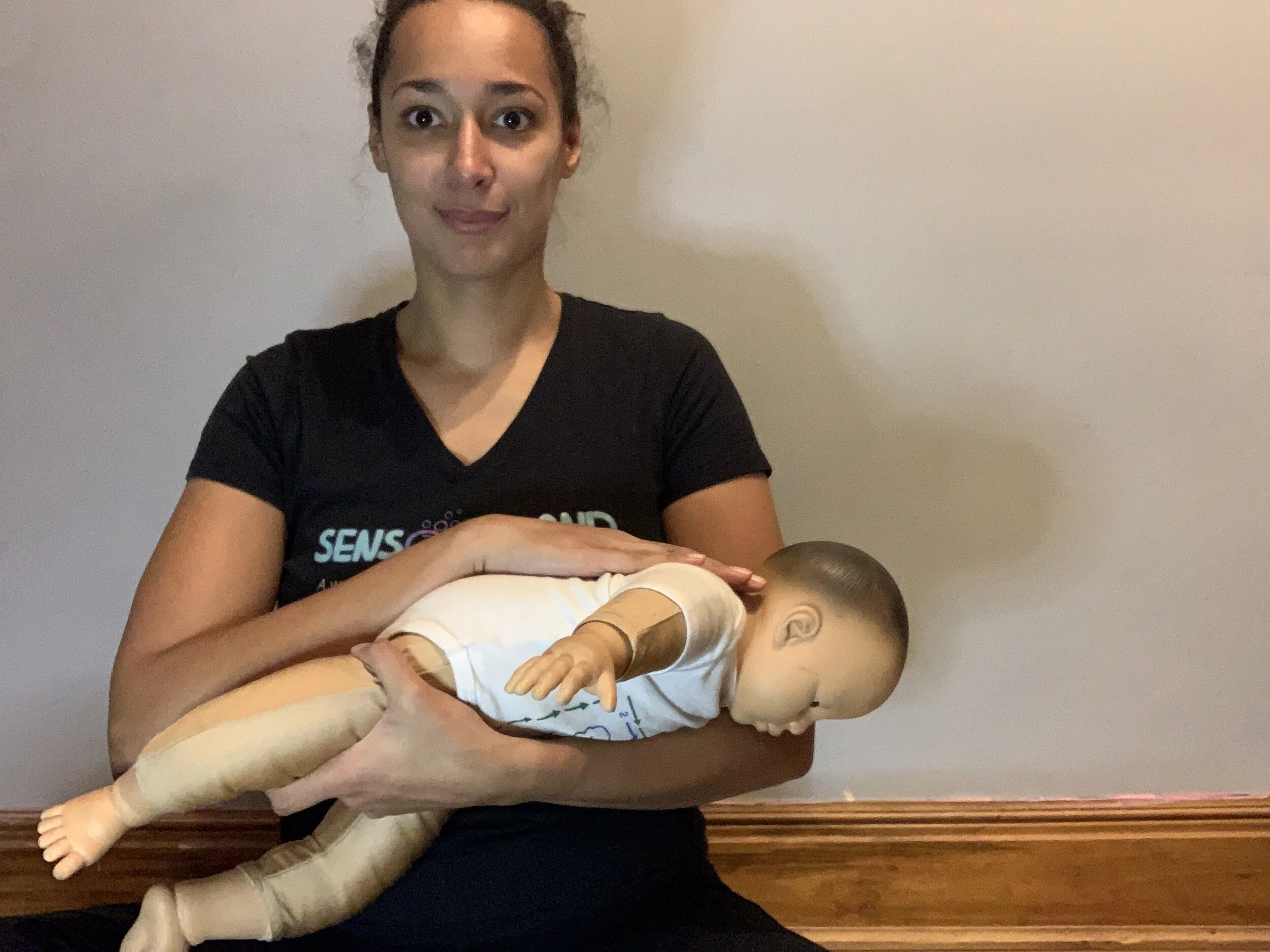 Rolled up towel under baby's legs hotsell